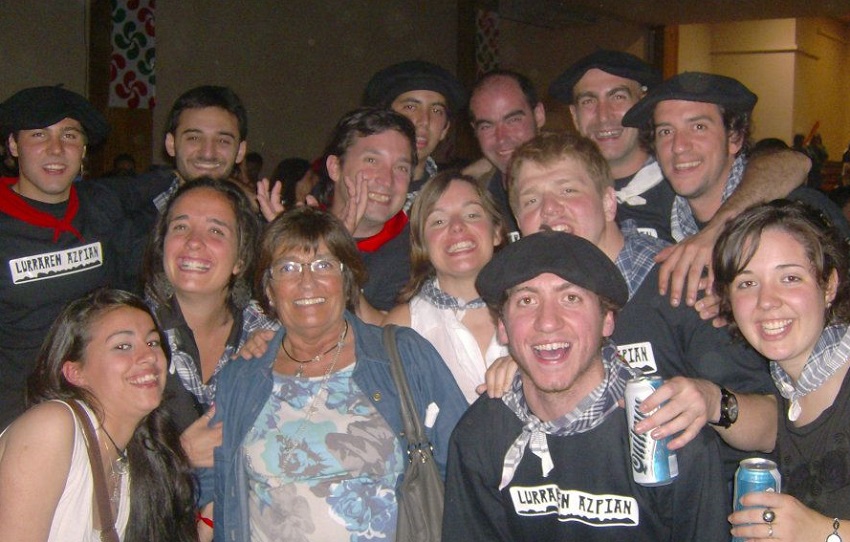 Alicia Aguirre surrounded by youth at the Euskal Etxea.  The photo is dated but it shows the special dedication she had for youth.  Some of those young people have picked up the torch she left behind and are keeping it alive