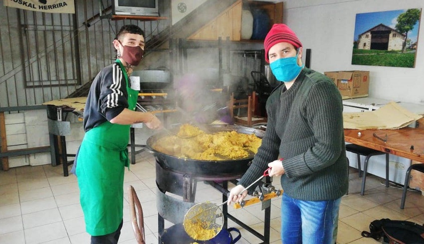 La nueva generación de sukaldaris del Centro nicoleño a cargo de las paellas, con barbijo y manteniendo la distancia