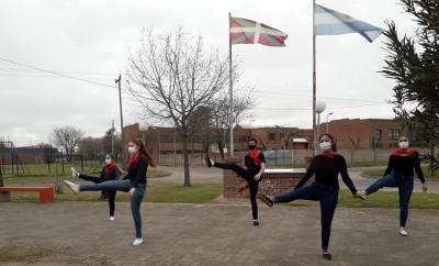 Dantzaris from Beti Aurrera dance to the Argentine flag on Flag Day