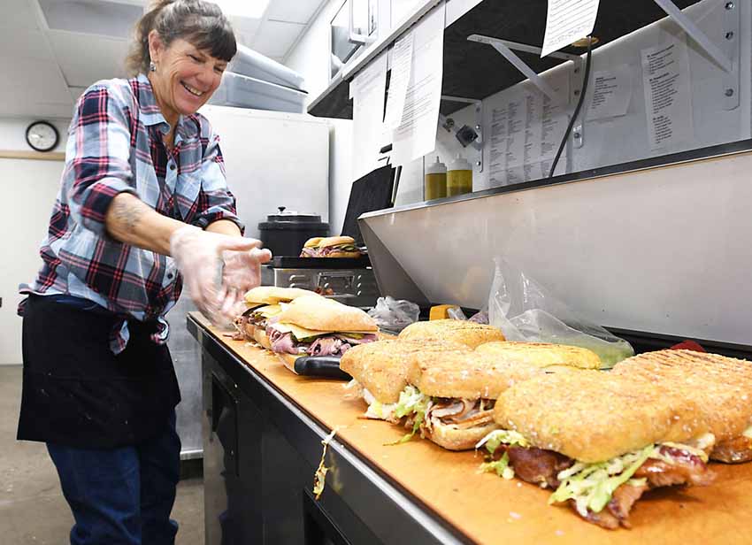Preparing famous Ogi sandwiches (photo Cynthia Delaney-Elko Daily Free Press)