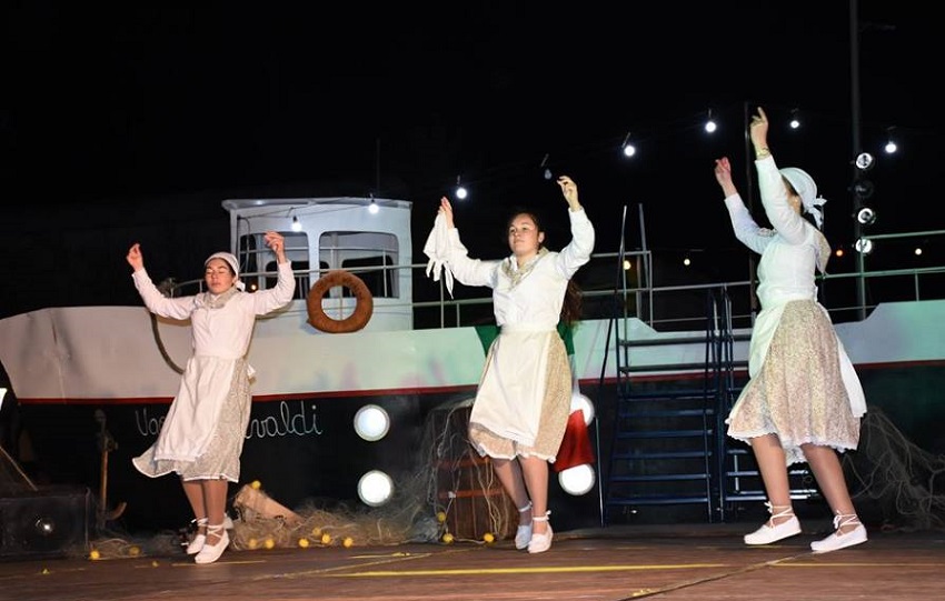 Dantzaris from Trenque Lauquen dancing in front of the boat in the “Immigrant” show 