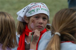 Una joven espera a que le pinten en la cara en la edición del año pasado (foto St.Teresa)