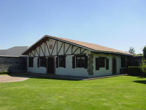 Headquarters of the Celaya Basque association, that includes the Basque farm style building, a green area and gardens, and a Basque handball or pelota court (photo EuskalKultura.com)