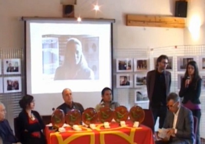 Harkaitz Cano, standing, receiving last year's Ostana Literary Prize