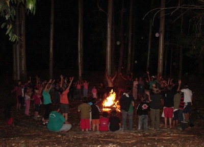 Imagen de archivo de una edición anterior del Udaleku de FIVU, con los participantes en el campamento estival reunidos junto al fuego (foto Udaleku-EuskalKultura.com)
