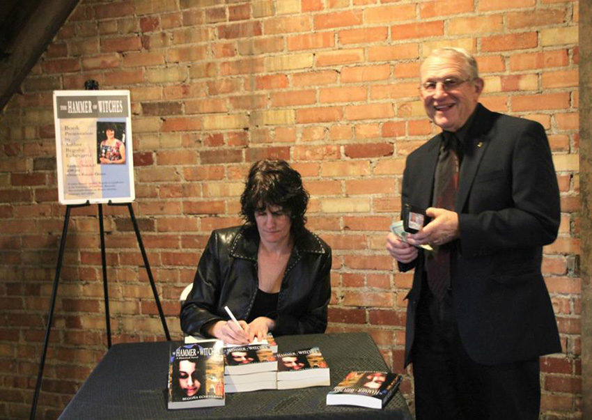 Begoña Echeverria signing her book at the presentation at the Ontario Basque Club