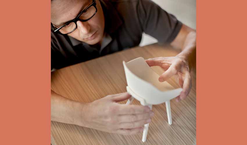 Basque designer, Jean Louis Iratzoki, with a model of the Kuskoa Bi chair by Alki (photo Mito-The NYT)